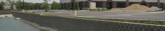 civil engineering picture of wall with water below and pavement